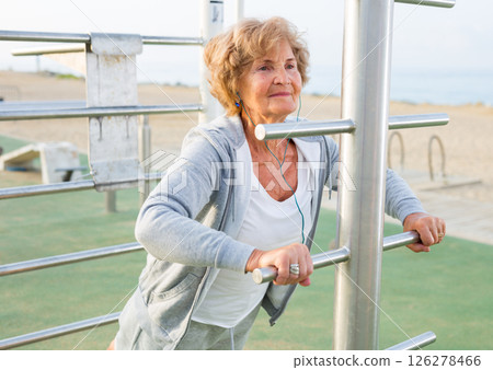 Elderly woman doing sports outdoors Elderly woman doing sports outdoors 126278466