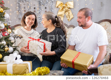 Happy family - adult children wishing Merry Christmas to their grandmother Happy family - adult children wishing Merry Christmas to their grandmother 126278468