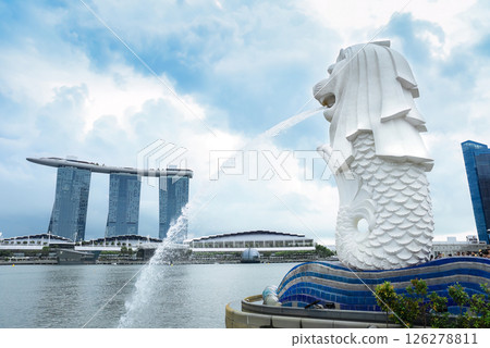 Singapore, Singapore - 4 April 2025: Editorial image of the iconic Merlion statue overlooking Marina Bay Sands under a dramatic cloudy sky, with no people in the scene Singapore, Singapore - 4 April 2025: Editorial image of the iconic Merlion statue overlooking Marina Bay Sands under a dramatic cloudy sky, with no people in the scene 126278811