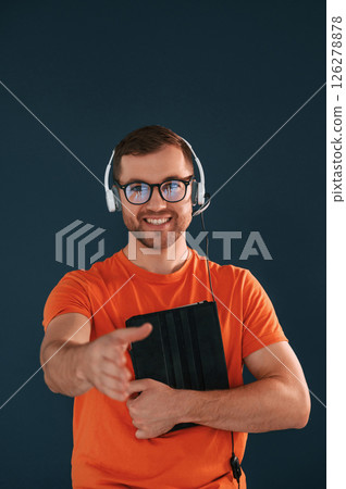 Handsome man is in the studio against blue background 126278878