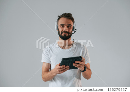 Handsome man is in the studio against white background 126279337