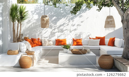 This inviting outdoor lounge features a spacious arrangement of white couches adorned with vibrant orange cushions. The area is enhanced by beautiful greenery and natural elements. This inviting outdoor lounge features a spacious arrangement of white couches adorned with vibrant orange cushions. The area is enhanced by beautiful greenery and natural elements. 126279862
