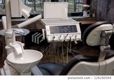 Dentist chair and equipment in a professional dental office Dentist chair and equipment in a professional dental office 126280564