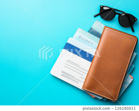 Wallet with a blue card and a brown card is on top of a blue background 126280811