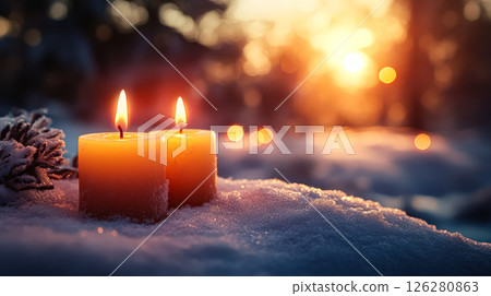 Two candles are lit on a snowy ground 126280863