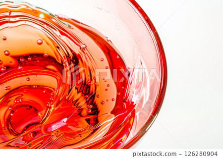 Glass of red liquid with bubbles in it 126280904