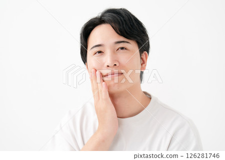 Smiling man touching his cheek 126281746