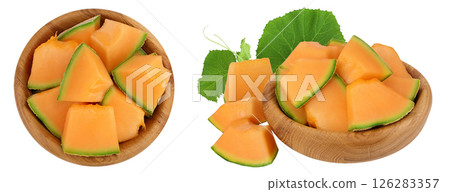 Cantaloupe melon pieces in wooden bowl isolated on white background with full depth of field. Top view. Flat lay Cantaloupe melon pieces in wooden bowl isolated on white background with full depth of field. Top view. Flat lay 126283357