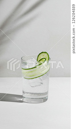 Refreshing cucumber infused sparkling water in glass with ice cubes 126284889