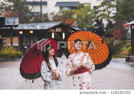 Two young women in yukata walking through a hot spring town [Filming cooperation: Shibata City Film Commission Council] 126285292
