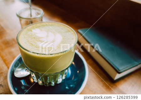 Reading with a matcha latte at a cafe Reading with a matcha latte at a cafe 126285399
