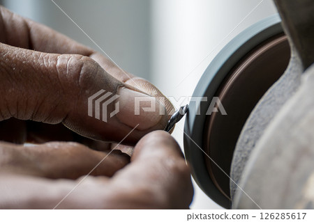 The small drill tool regrind process by manual operation with abrasive wheel. 126285617