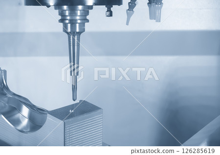 The 5 axis CNC milling machine cutting mold part by solid ball nose end mill tool in the light blue scene. 126285619