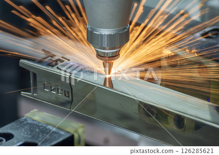 Close up scene the fiber laser cutting machine cut the square shape stainless steel tube with sparkling light. Close up scene the fiber laser cutting machine cut the square shape stainless steel tube with sparkling light. 126285621