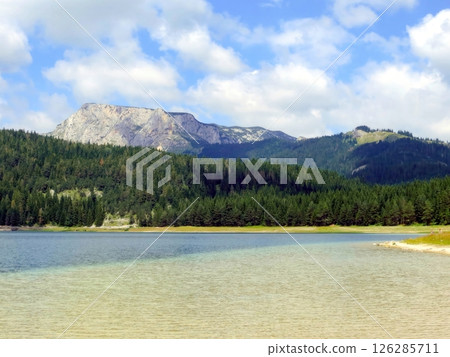 Discover the Beauty of Black Lake in Durmitor National Park, Montenegro Surrounded by Lush Mountains 126285711