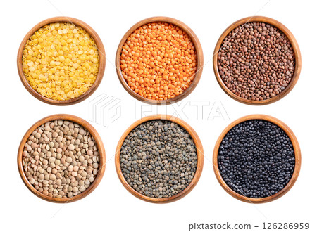 Lentils, dried seeds of Lens esculenta in wooden bowls. Yellow, red, and brown or unshelled mountain lentils in the top row, large green plate lentils, Puy, and Beluga lentils in the bottom row. Lentils, dried seeds of Lens esculenta in wooden bowls. Yellow, red, and brown or unshelled mountain lentils in the top row, large green plate lentils, Puy, and Beluga lentils in the bottom row. 126286959