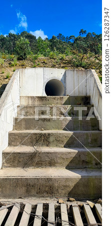 Large concrete pipe for drainage in the rocky regions of Portugal. Concept for drainage works, water treatment, slope stabilization in building construction 126287347