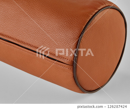 Close-up of cylindrical leather object showing stitching and texture 126287424
