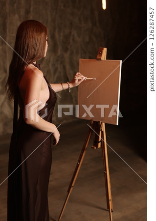 Artistic Expression A Woman Engaged in the Process of Painting in a Studio Setting Artistic Expression A Woman Engaged in the Process of Painting in a Studio Setting 126287457