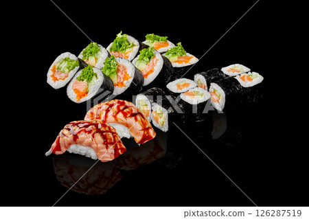 Sushi set with salmon, avocado and cucumber filling on black background Sushi set with salmon, avocado and cucumber filling on black background 126287519
