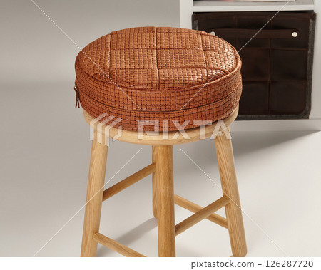 Round leather cushion resting on wooden stool: interior design inspiration 126287720
