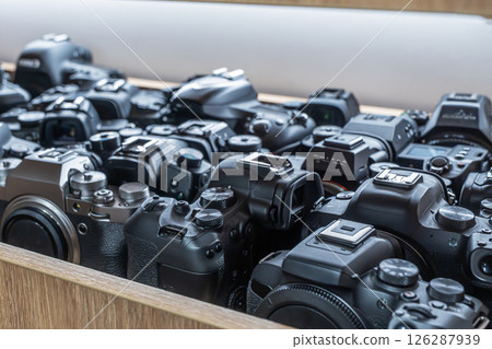 Lots of cameras on the shelf Wide selection of cameras available for rental or sale at local shop, showcasing various models and types for photography enthusiasts 126287939