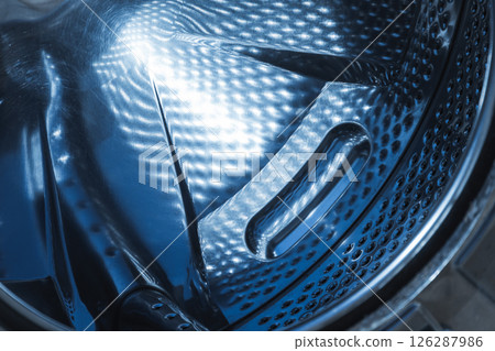 Reflective stainless steel interior of a washing machine drum 126287986