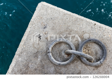 A detailed view of two interlinked mooring rings, top view A detailed view of two interlinked mooring rings, top view 126288004