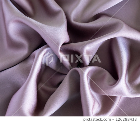 Luxurious folds of soft lavender silk fabric with smooth texture and shine 126288438