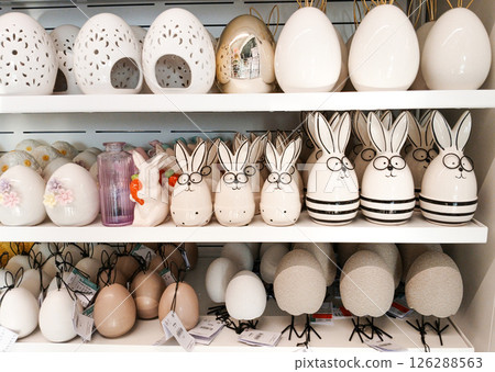 Kamyanets-Podilskyi, Ukraine - April 4, 2025 - Easter-themed ceramic decorations are displayed on store shelves. Kamyanets-Podilskyi, Ukraine - April 4, 2025 - Easter-themed ceramic decorations are displayed on store shelves. 126288563
