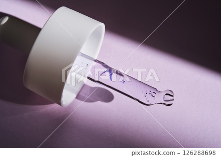 Pipette with serum on purple background with sunlight. 126288698