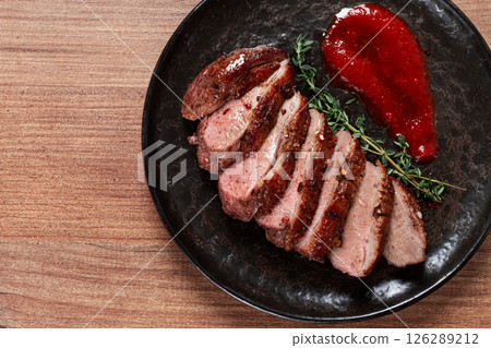 roast duck breast, sliced on a plate, with red sauce, homemade, no people, roast duck breast, sliced on a plate, with red sauce, homemade, no people, 126289212