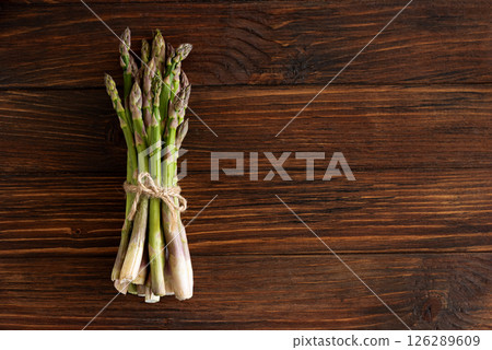 Asparagus tied bundle on rustic table. Top view Asparagus tied bundle on rustic table. Top view 126289609
