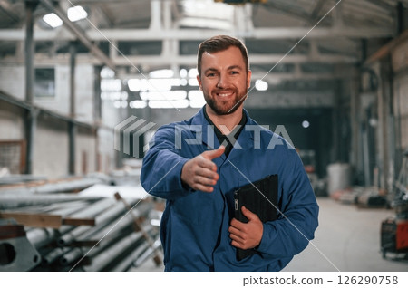 Factory worker in blue uniform is indoors 126290758