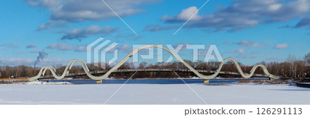 Kyiv, Ukraine February 16, 2025: New bridge "Volna" Obolonsky island Park "Natalka" in Kyiv Kyiv, Ukraine February 16, 2025: New bridge "Volna" Obolonsky island Park "Natalka" in Kyiv 126291113