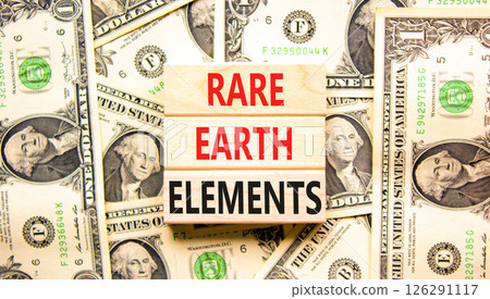 Rare earth elements symbol. Concept words Rare earth elements on beautiful wooden blocks. Dollar bills. Beautiful background from dollar bills. Business and rare earth elements concept. Copy space. 126291117