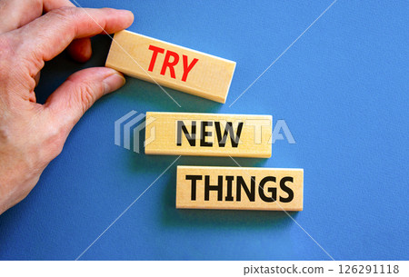 Try new things symbol. Concept words Try new things on beautiful wooden block. Businessman's hand. Beautiful blue background. Business motivational lifestyle try new things concept. Copy space. Try new things symbol. Concept words Try new things on beautiful wooden block. Businessman's hand. Beautiful blue background. Business motivational lifestyle try new things concept. Copy space. 126291118