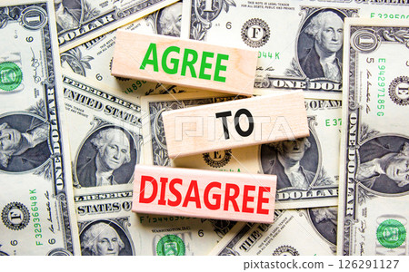 Agree to disagree symbol. Concept words Agree to disagree on beautiful wooden blocks. Dollar bills. Beautiful background from dollar bills. Business and agree to disagree concept. Copy space. 126291127