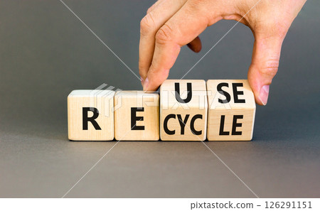 Reuse or recycle symbol. Concept words Reuse Recycle on wooden block. Beautiful grey table grey background. Businessman hand. Business reuse or recycle concept. Copy space. 126291151