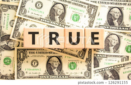 True symbol. Concept word True on beautiful wooden blocks. Dollar bills. Beautiful background from dollar bills. Business, lifestyle, support and true concept. Copy space. 126291155