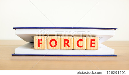 Force symbol. Concept word Force on beautiful wooden blocks in book. Beautiful wooden table white background. Business lifestyle force concept. Copy space. 126291201
