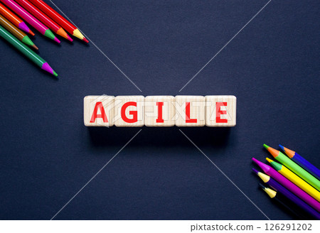 Agile symbol. Concept word Agile on beautiful wooden blocks. Beautiful black table black background. Beautiful colored pencils. Business agile concept. Copy space. Agile symbol. Concept word Agile on beautiful wooden blocks. Beautiful black table black background. Beautiful colored pencils. Business agile concept. Copy space. 126291202