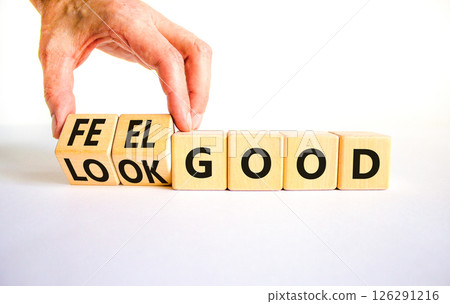 Look and feel good symbol. Concept words Look good Feel good on wooden cubes. Beautiful white table white background. Doctor hand. Healthy lifestyle look and feel good concept. Copy space. 126291216