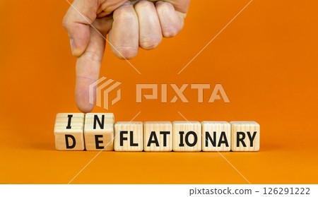 Deflationary or inflationary symbol. Concept words Deflationary Inflationary on wooden blocks. Beautiful orange background. Businessman hand. Business deflationary inflationary concept. Copy space 126291222