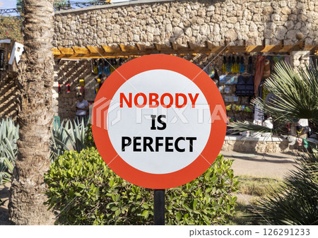 Nobody is perfect symbol. Concept words Nobody is perfect on beautiful white road sign. Beautiful palm tree hotel background. Business motivational lifestyle and nobody is perfect concept. Copy space. 126291233