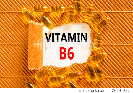 Vitamin B6 symbol. Concept words Vitamin B6 on beautiful white paper. Yellow pills tablets. Beautiful brown background. Medical healthy lifestyle Vitamin B6 concept. Vitamin B6 symbol. Concept words Vitamin B6 on beautiful white paper. Yellow pills tablets. Beautiful brown background. Medical healthy lifestyle Vitamin B6 concept. 126291282