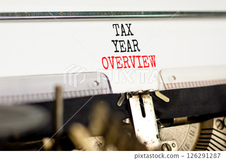 Tax year overview symbol. Concept words Tax year overview typed on beautiful old retro vintage typewriter. Beautiful white background. Business tax year overview concept. Copy space. 126291287