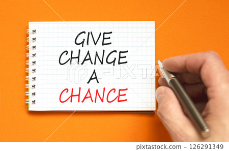 Give change a chance symbol. Concept words phrase Give change a chance on beautiful white note. Businessman's hand. Beautiful orange background. Business Give change a chance concept. Copy space. 126291349