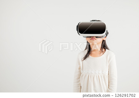 Smiling young kid girl confidence excited wear VR headset device during virtual reality experience isolated white background, Asian happy portrait kindergarten child playing video game studio shot 126291702