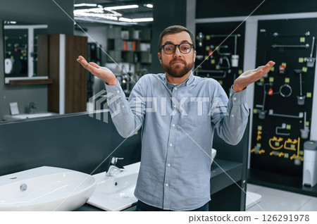 Don't know what to buy, what to do. Man chooses a products in a sanitary ware store 126291978